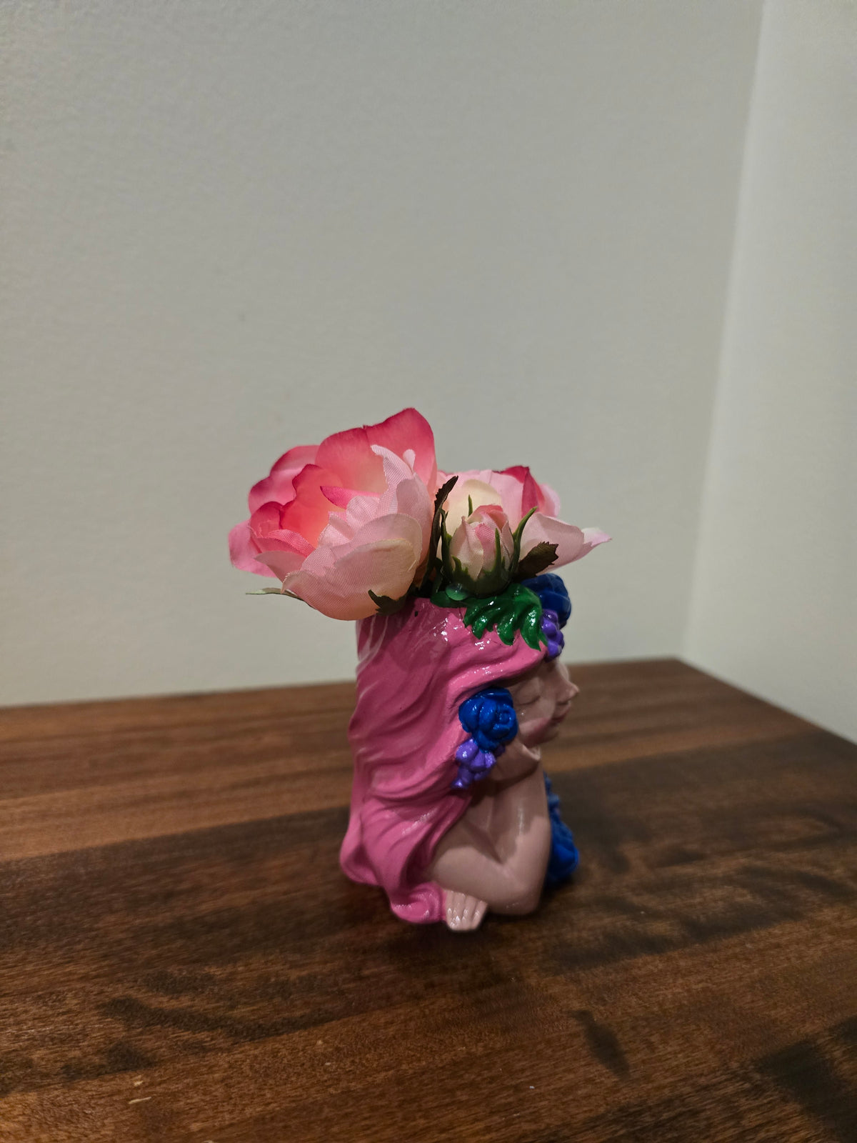Pink little girl with Artificial Flowers.
